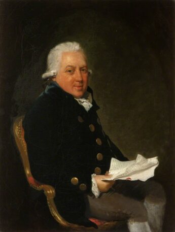 A seated gentleman in eighteenth century costume holds a paper in his hand. His hair is curled and powdered and he has a prosperous air. This is a portrait of Alexander Campbell a planter and slave owner from the island of Grenada.