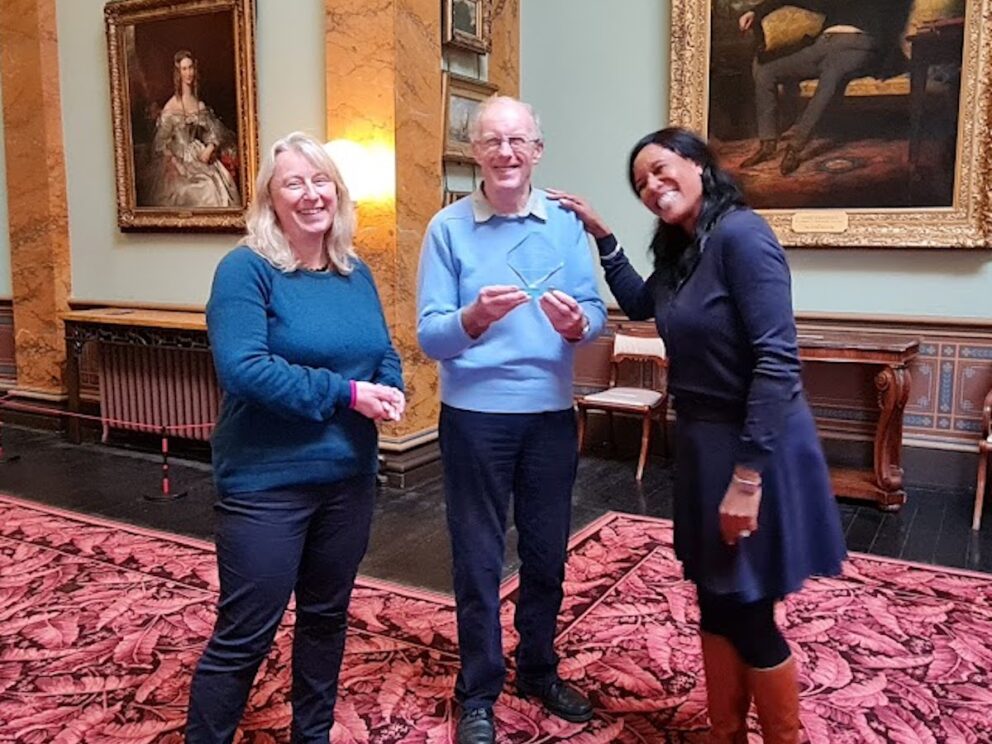 Fiona Murrell, John Home Robertson receive the glass trophy that is a Young Ealing Foundation Award from Chantel Noel of Descendants in the historic regency picture gallery at Paxton House