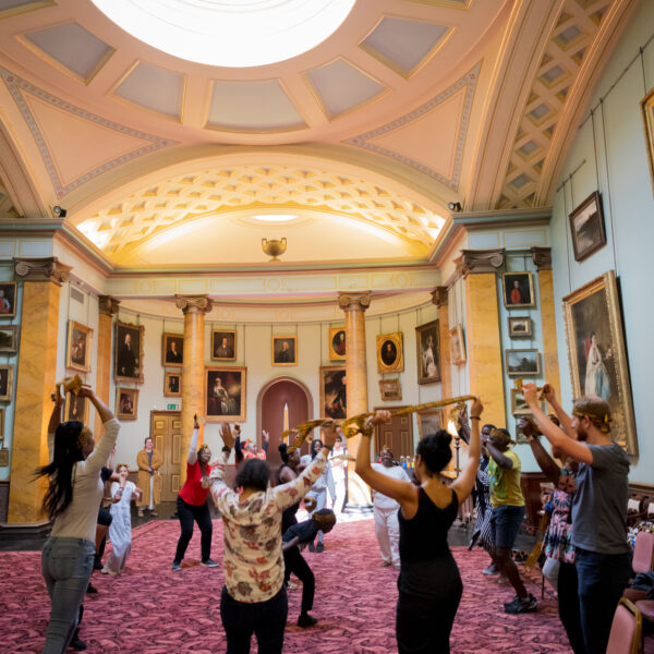 Group of people visiting Paxton on an event day dancing in the Picture Gallery