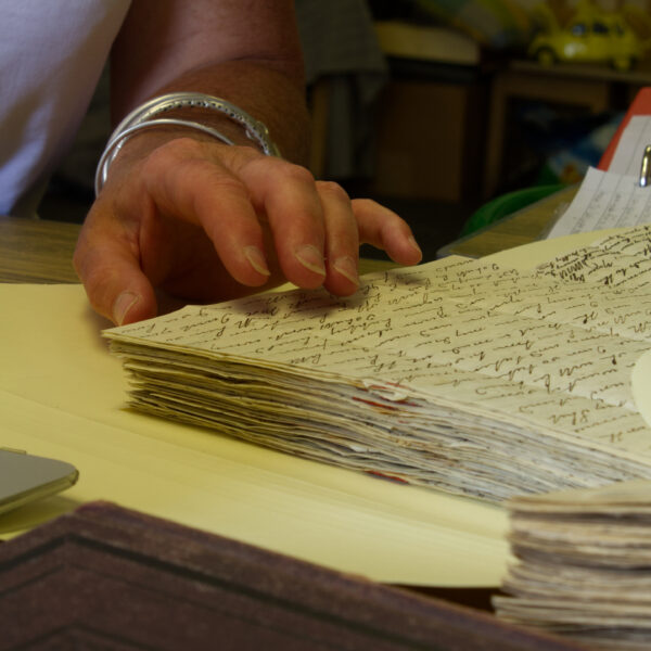 Archivist reading handwritten letters
